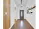 Inviting home foyer with modern light fixture, wood accent wall, and decorative wall decor at 421 Sierra Mike Blvd, Lake Alfred, FL 33850