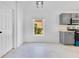 Eat-in kitchen area with stainless appliances, grey cabinets, and a bright window at 421 Sierra Mike Blvd, Lake Alfred, FL 33850