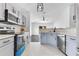 Updated kitchen with stainless steel appliances, stylish subway tile, and light blue cabinets at 421 Sierra Mike Blvd, Lake Alfred, FL 33850