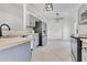 Charming kitchen features stainless steel appliances, gray cabinets, and light countertops at 421 Sierra Mike Blvd, Lake Alfred, FL 33850