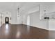 Bright open-concept living space with archways, hardwood flooring, and a modern light fixture at 421 Sierra Mike Blvd, Lake Alfred, FL 33850