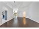 Open concept living room with hardwood floors and archways leading to other spaces at 421 Sierra Mike Blvd, Lake Alfred, FL 33850