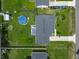 Aerial view of home showcasing the large backyard with a deck and above-ground pool at 4730 Se 141St Pl, Summerfield, FL 34491