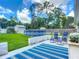 Lush backyard with an above-ground pool, shed and comfortable seating area at 4730 Se 141St Pl, Summerfield, FL 34491