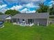 Aerial view of the expansive backyard showcasing the lush lawn and patio area at 4730 Se 141St Pl, Summerfield, FL 34491