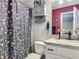 Cozy bathroom with patterned shower curtain, vanity, and cabinet at 4730 Se 141St Pl, Summerfield, FL 34491