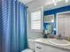 Well-lit bathroom with blue accents, featuring a shower and vanity area at 4730 Se 141St Pl, Summerfield, FL 34491