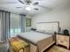 Cozy bedroom showcasing a ceiling fan, bedside tables, and a comfortable king bed at 4730 Se 141St Pl, Summerfield, FL 34491