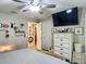 Bright bedroom with ceiling fan, dresser with TV and a walk in to the mirror hallway at 4730 Se 141St Pl, Summerfield, FL 34491