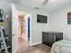Bright bedroom featuring an ensuite bathroom and modern media at 4730 Se 141St Pl, Summerfield, FL 34491