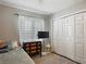 Cozy bedroom featuring a ceiling fan, ample closet space, and modern TV display at 4730 Se 141St Pl, Summerfield, FL 34491
