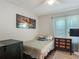 Comfortable bedroom featuring a ceiling fan, natural light, and modern media at 4730 Se 141St Pl, Summerfield, FL 34491