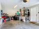 Spacious garage with overhead door opener and ample storage, featuring an epoxy floor at 4730 Se 141St Pl, Summerfield, FL 34491