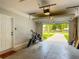 Open garage featuring a motorcycle and a view of the street at 4730 Se 141St Pl, Summerfield, FL 34491