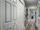 Hallway with a series of decorative mirrors adorning the wall at 4730 Se 141St Pl, Summerfield, FL 34491