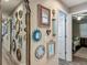 Unique hallway featuring an array of decorative mirrors, creating an artistic and bright space at 4730 Se 141St Pl, Summerfield, FL 34491