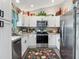 Bright kitchen with white cabinets, stainless steel appliances, and granite countertops at 4730 Se 141St Pl, Summerfield, FL 34491