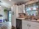 Bright and functional kitchen with stainless steel appliances and outdoor access to the yard at 4730 Se 141St Pl, Summerfield, FL 34491