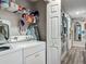 Laundry area equipped with a washer, dryer, and shelving for storage at 4730 Se 141St Pl, Summerfield, FL 34491