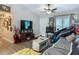 Cozy living room with hardwood floors, stylish furniture, modern lighting, and vaulted ceilings at 4730 Se 141St Pl, Summerfield, FL 34491