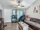 Comfortable living room features wood flooring, a relaxing massage chair and bright window shutters at 4730 Se 141St Pl, Summerfield, FL 34491