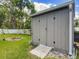 Backyard shed featuring a ramp, set on a grassy lot perfect for outdoor storage at 4730 Se 141St Pl, Summerfield, FL 34491