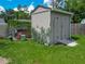 Outdoor shed with a ramp, surrounded by a chicken coop and lush green lawn at 4730 Se 141St Pl, Summerfield, FL 34491