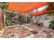 Backyard patio with unique tiled flooring, partial shade, decorative elements, and yard access at 536 Ave G Se, Winter Haven, FL 33880