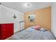 Bedroom with brightly painted walls, a window for natural light, and a red dresser at 536 Ave G Se, Winter Haven, FL 33880