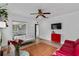 Bright living room featuring tile flooring, a modern sofa, and lots of natural light at 536 Ave G Se, Winter Haven, FL 33880