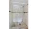This shower has white tile on the wall and marble look tile on the floor at 536 Ave G Se, Winter Haven, FL 33880