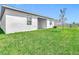 Back of home featuring a covered porch, new construction, and well-maintained lawn at 800 Reggie Rd, Winter Haven, FL 33884