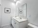 Beautiful bathroom with double sink vanity, white cabinets, and tiled floors at 800 Reggie Rd, Winter Haven, FL 33884