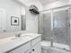Modern bathroom with a sleek vanity, glass-enclosed shower, neutral tile, and modern fixtures at 800 Reggie Rd, Winter Haven, FL 33884