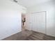 Neutral bedroom showing a glimpse into another room, with closet doors and carpeted floors at 800 Reggie Rd, Winter Haven, FL 33884