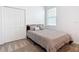 Cozy bedroom with a comfortable bed, soft neutral carpet, double door closet and a bright window at 800 Reggie Rd, Winter Haven, FL 33884