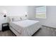 Cozy bedroom with sconce lighting, and a bright window with outdoor view at 800 Reggie Rd, Winter Haven, FL 33884