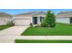 Charming single-Gathering home with well-manicured lawn and freshly landscaped front yard at 800 Reggie Rd, Winter Haven, FL 33884