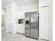 Modern kitchen features stainless steel refrigerator, white cabinets, and lots of storage space at 800 Reggie Rd, Winter Haven, FL 33884