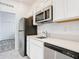 Efficient kitchen featuring stainless steel appliances, white cabinets, and bright counter tops at 800 Reggie Rd, Winter Haven, FL 33884