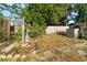 Expansive backyard with mature trees, wooden fencing, and partial patio; offers privacy and space at 1852 E Fern Rd, Lakeland, FL 33801