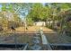A backyard with raised garden beds, a slide, and partial fencing, ideal for outdoor fun at 1852 E Fern Rd, Lakeland, FL 33801