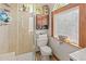 Bright bathroom featuring a glass-door shower and natural light from the arched window at 1852 E Fern Rd, Lakeland, FL 33801