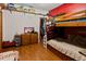 Bedroom featuring a bunk bed and wooden dresser in a cozy space at 1852 E Fern Rd, Lakeland, FL 33801