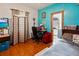 Comfortable bedroom featuring hardwood floors, a work space, and plenty of natural light at 1852 E Fern Rd, Lakeland, FL 33801
