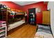 Red walled bedroom featuring wooden bunk beds and ample storage at 1852 E Fern Rd, Lakeland, FL 33801