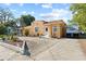 A wide driveway leads to this quaint stucco home with mature landscaping and a recreational vehicle at 1852 E Fern Rd, Lakeland, FL 33801