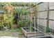 Backyard garden area with raised beds, trellis fencing, and lush greenery at 1852 E Fern Rd, Lakeland, FL 33801