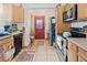 Well-lit kitchen featuring tile floors, stainless steel appliances, and wooden cabinets at 1852 E Fern Rd, Lakeland, FL 33801