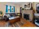 Inviting living room with a brick fireplace, hardwood floors, and comfortable seating at 1852 E Fern Rd, Lakeland, FL 33801